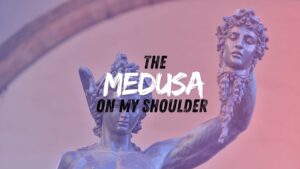 The words "The Medusa On My Shoulder" appear painted over a colorized image of a statue of Perseus showing off Medusa's head.